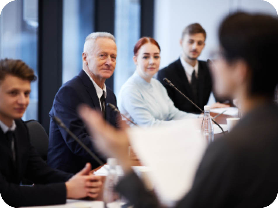 Group of business people sitting in row and listening to presentation in conference room, copy space
