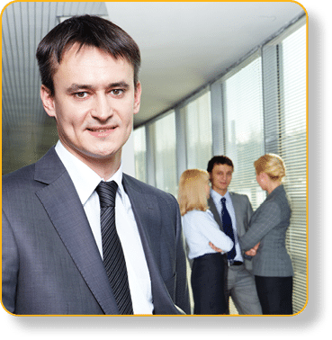 Portrait of a young confident businessman with working team on background