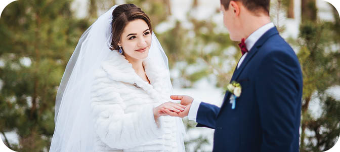 Happy bride and groom in winter day on their wedding, photo session.