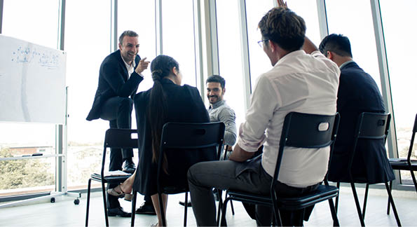 Employees raise their hands to inquire about the work in the company. Chief answers questions to those are suspected in the meeting.